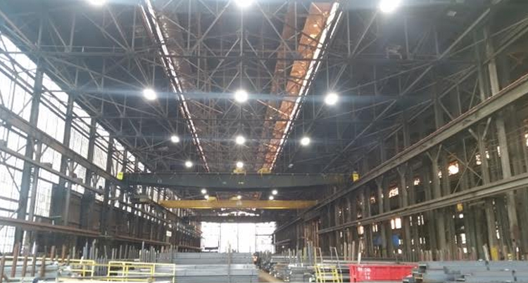 picture of a steel warehouse with a lighting retrofit job, picture of a steel warehouse with high bay led lighting